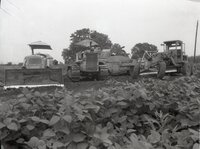 Three Pieces of Farm Machinery Stand in a Row