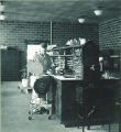 Student loading a centrifuge, The University of Iowa, 1950s