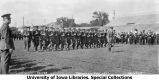 Governor's Day pass and review with officer in foreground, Iowa Field, The University of Iowa, 1927