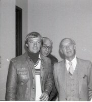 Three men pose for photo