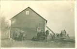 Men filling the corn crib on farm, Iowa, 1900s