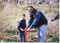 2002  Terrence Rudolph helps girl scout plant a tree