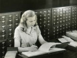Student checking reference material, 1948