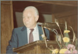 Earl O. Heady standing behind a lectern