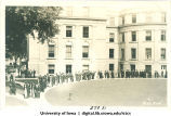 Procession of graduates near McBride Hall on Class Day, The University of Iowa, 1920s