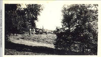 Many men loading hay wagon in hayfield