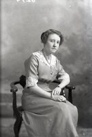 Woman seated with necklace