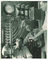 Engineering instructor giving hands-on instruction to students in engineering laboratory, The University of Iowa, 1939