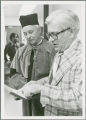 Earl O. Heady and Raymond Beneke reviewing the award inscription related to Heady's Polish honorary doctorate degree, 1979
