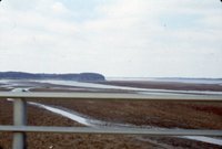 Road bridge overlooking unidentified body of water, 1980s