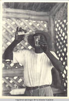 Unknown man with bottle of Schweppes