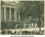 Women dressed as fairies performing in front of the Old Capitol at a June celebration, The University of Iowa, 1920