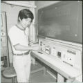 Researcher with large piece of equipment, 1978