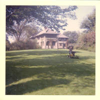 Leo cutting the Grey house lawn with riding mower