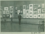 Looking at art displayed in the Art Building, the University of Iowa, 1930s?