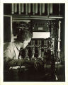 Engineering student working in a technology laboratory with a telephone, The University of Iowa, 1939