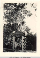 Vidie Burden and Norm Kirch sitting on top of the Playhouse arbor
