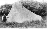 Man standing next to The Sentinel, Newton Township, Iowa, late 1890s or early 1900s