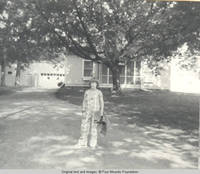 John, Jr. standing on lane with towel in hand