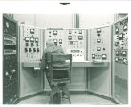 Physics student operating control panel for 5.5 MeV Van de Graaff accelerator, The University of Iowa, 1969