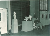 Reading near sculptures in the Art Building, the University of Iowa, October 1947