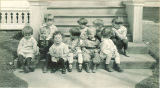 Small children sitting on porch steps, The University of Iowa, 1920s