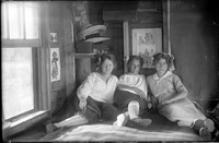 UP 201  Three women on bed in cabin