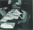 Student looking at botanical drawings, The University of Iowa, 1930s