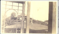 Grey house view through White house rear porch