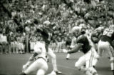 ISU quarterback throwing a pass during the Homecoming football game, 1985