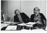 Three unidentified people at unidentified meetings