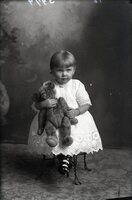 Toddler seated with bear