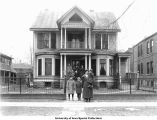 People posed in front of nursing home, Iowa City, Iowa, February 1921