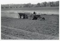 1978 Man on tractor with wagon plants seed