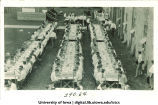 Men dining outdoors at  banquet tables, The University of Iowa, 1910s