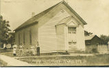 Group posing in front of an Evangelical church, Radcliffe, Iowa, 1910s