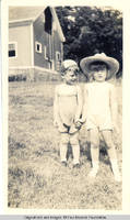 Norm Kirch and Vidie Burden behind the barn