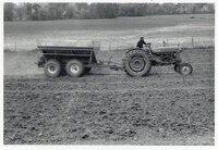 1978 Man on tractor with wagon plants seed