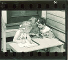 Girls writing at a table outside, The University of Iowa, May 10, 1941