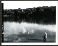 Man Casts Fishing Line into Water 