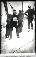 Ski men ascending hill
