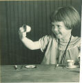 Girl playing with a toy tea set, The University of Iowa, 1920s