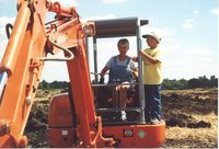 Woman and young boy on backhoe