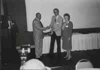 Unidentified man receiving award at Conservation Award Banquet in 1992