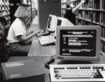 Student using early library computer