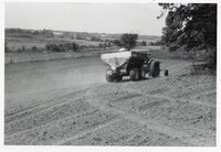 1978 Man on tractor with wagon plants seed