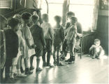 Line of small children in a playroom, The University of Iowa, 1920s