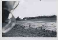 Farm and crop land with a fence that separates the crop land from grassland