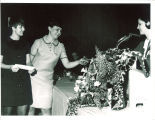 Scottish Highlanders lead dancer Bonnie Luzius and lead drummer Marcia Nice receiving Adamson-Highlander scholarship from drum major Kathy Monahan, The University of Iowa, ca. 1968