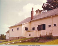 Rear of barn with top half of barn door open